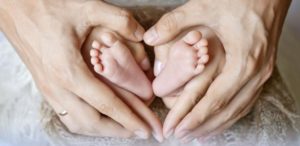 baby feet in adult hands